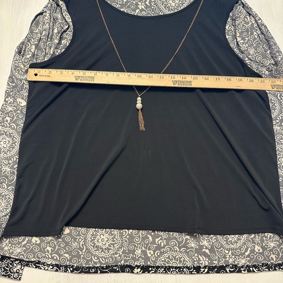 Elegant Black and White Blouse with Layered Design - Picture 3 of 11